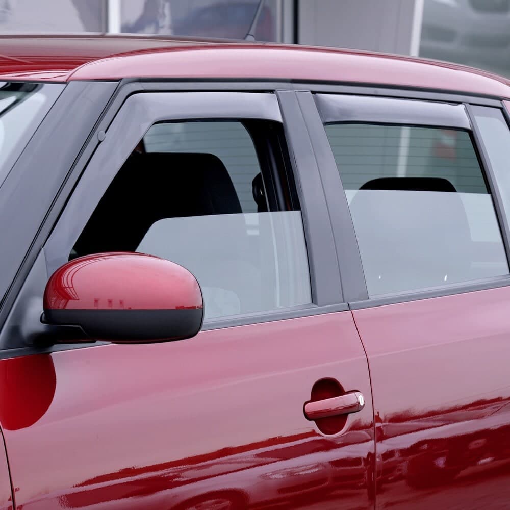 Close-up of a SATUNA deflector mounted in a car door window channel