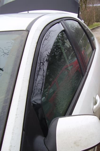 SATUNA wind deflector fitted to the front door window of a white car
